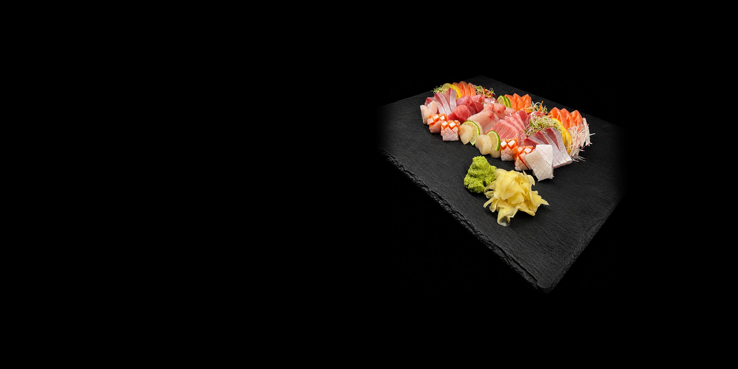 A sashimi platter on slate